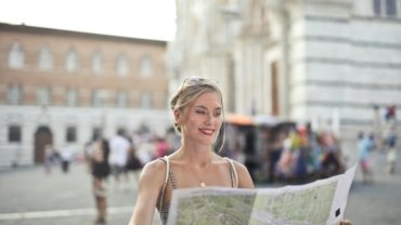 Solo traveler exploring a picturesque European city, enjoying cultural landmarks and vibrant street life