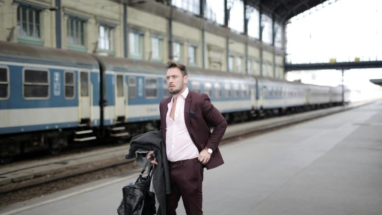 Man traveling with a secure and stylish crossbody bag in a city environment