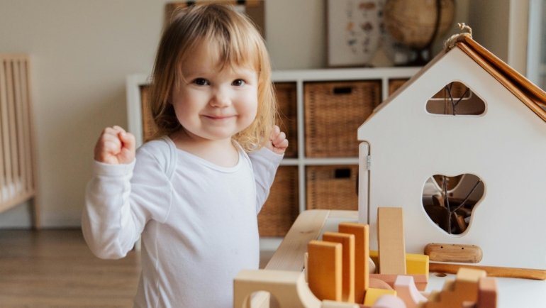 Toddler playing with compact travel toys to stay entertained during a family trip