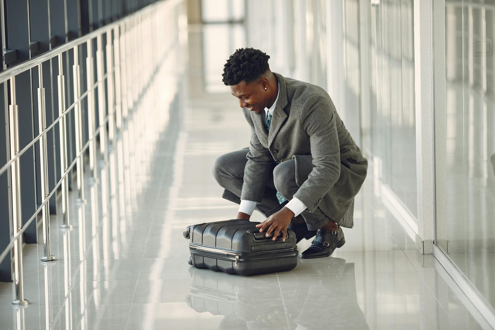Business traveler wearing a wrinkle-resistant travel suit walking confidently through an airport terminal