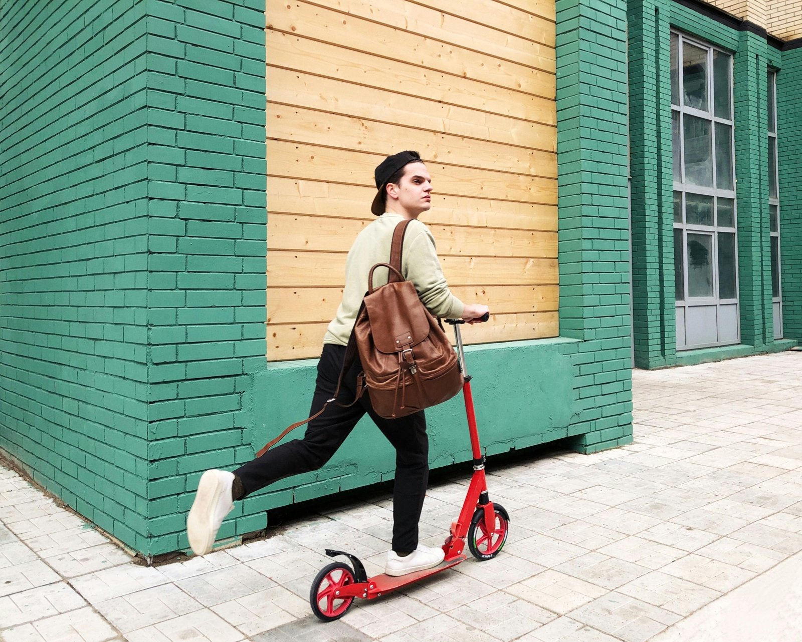 Traveler with a small backpack walking through a busy urban street symbolizing light and flexible travel