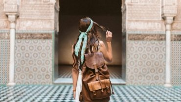 Solo female traveler exploring a vibrant city street, symbolizing safety and adventure for women traveling alone