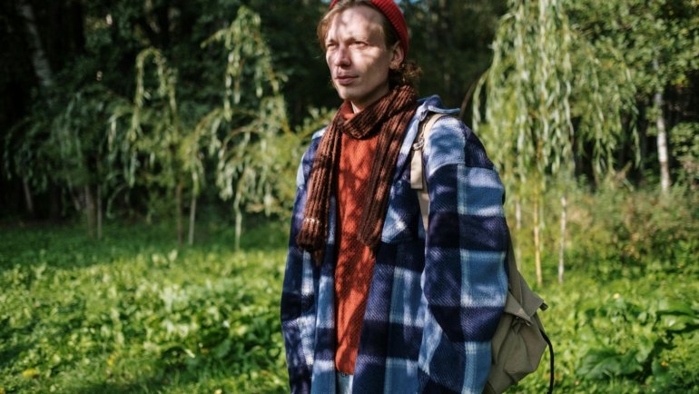 Traveler wearing a cozy and versatile travel wrap scarf outdoors during a cool day