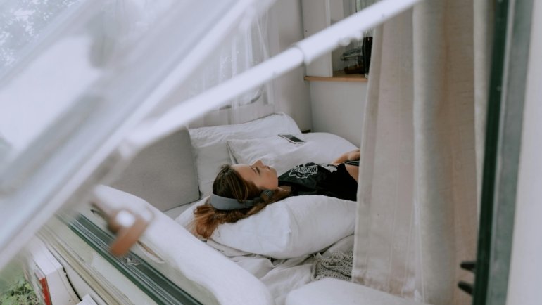 Traveler using a Tempur memory foam travel pillow for neck support and comfort during long trips