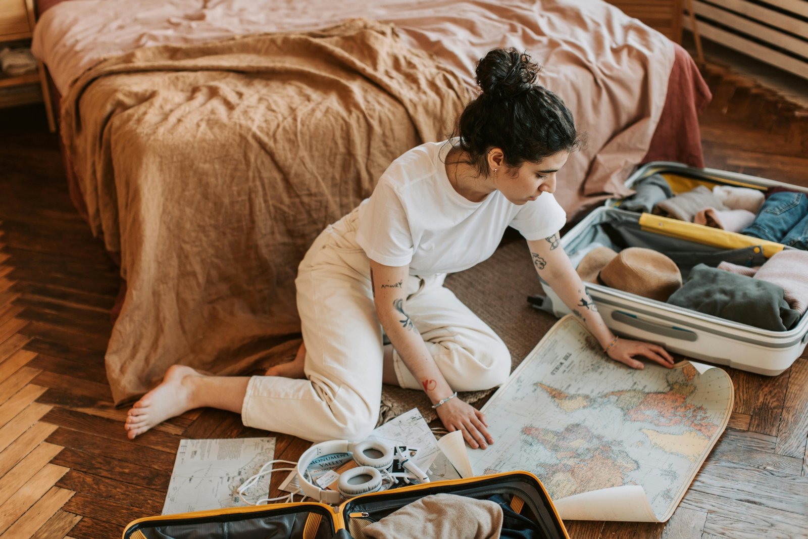 Traveler with luggage and world map ready for adventure and exploration