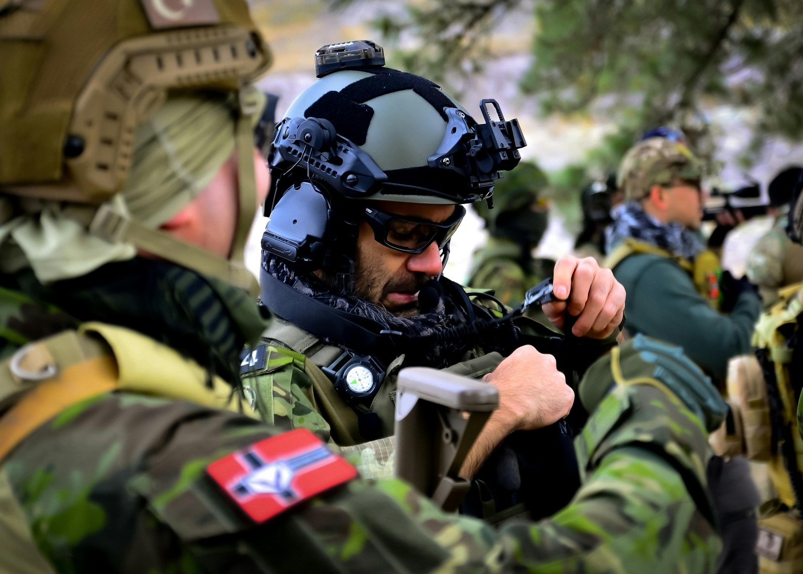 Military personnel reviewing travel documents and security briefings prior to overseas deployment