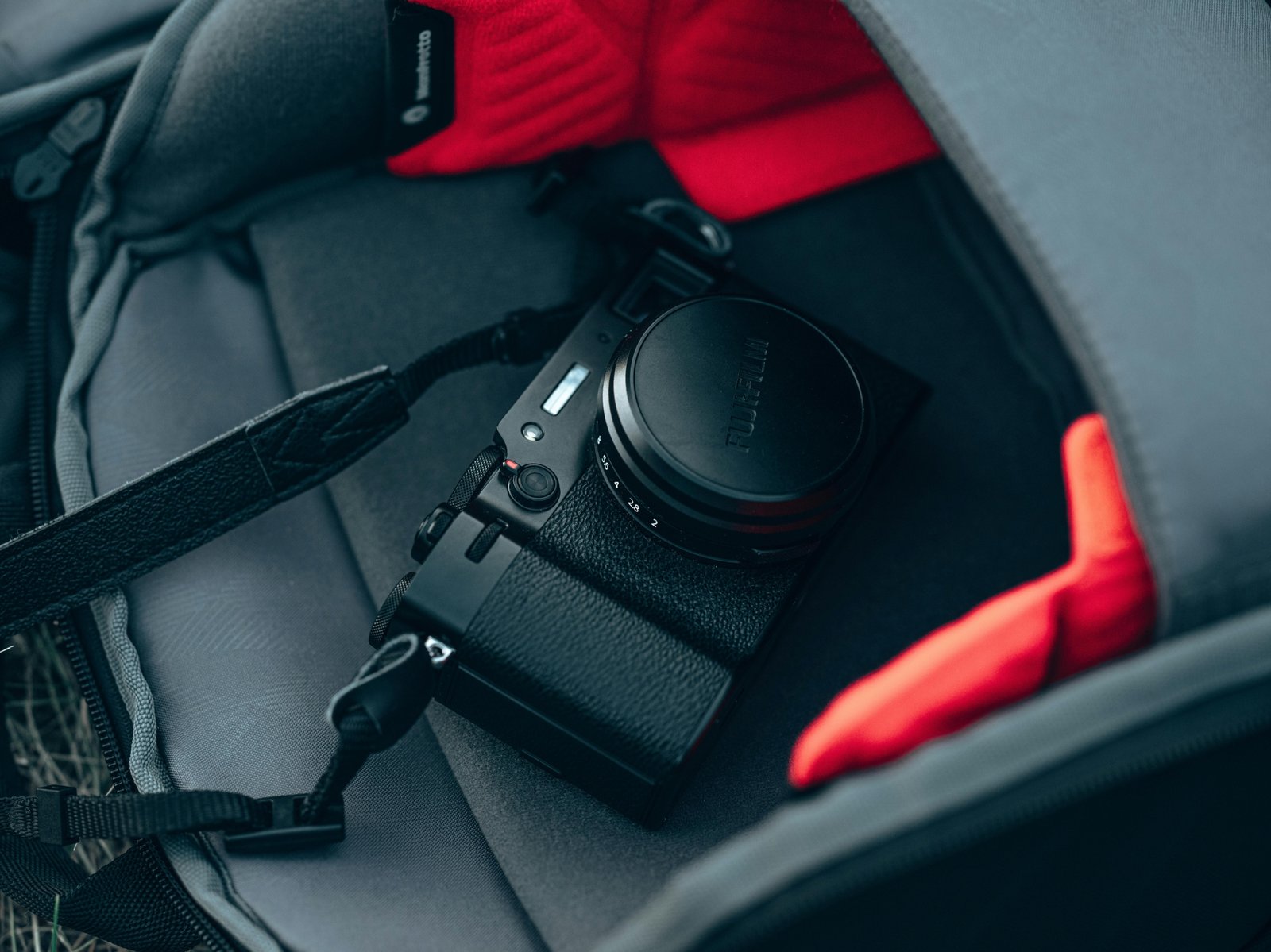 Compact travel camera in a backpack ready for adventure and photography on the go