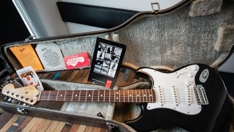 Durable guitar travel case protecting acoustic guitar during travel