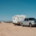 Gooseneck travel trailer hitched to pickup truck showcasing spacious design and stability for comfortable road trips