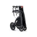 Lightweight travel wheelchair folded and ready for transportation at an airport, showcasing portability and user comfort.