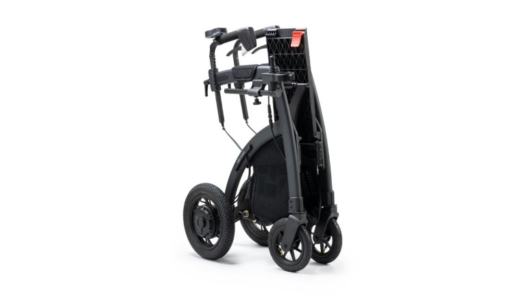 Lightweight travel wheelchair folded and ready for transportation at an airport, showcasing portability and user comfort.
