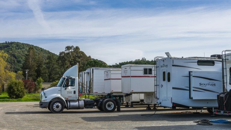 Ozark Travel Center roadside rest stop with fuel pumps, picnic area, and travelers enjoying a break during a scenic road trip