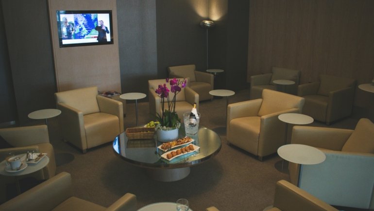 Elite traveler relaxing in a luxury airport lounge with exclusive amenities and priority services