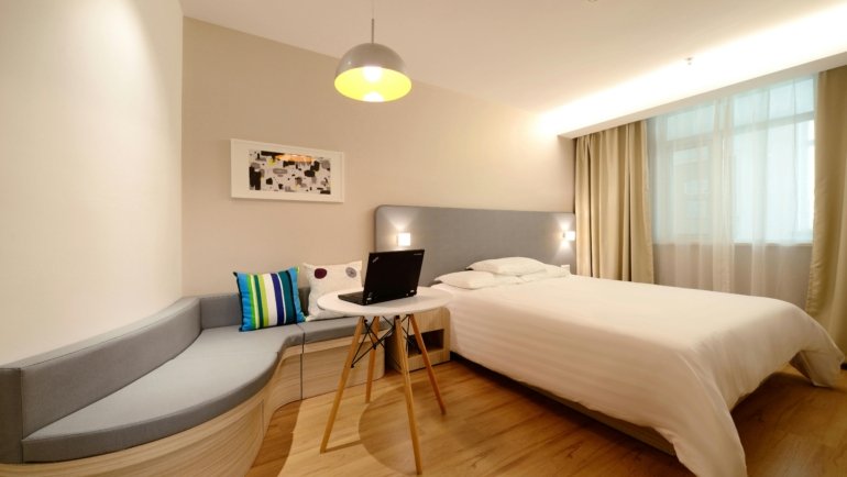 Cozy and affordable budget hotel room with essential amenities and warm lighting