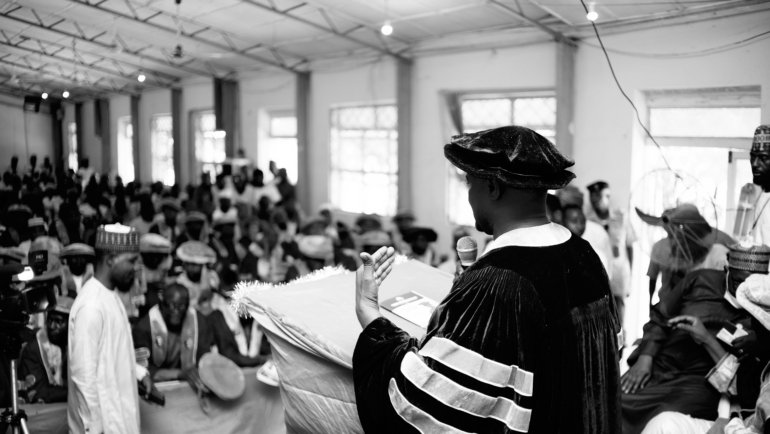 Graduate student preparing for academic conference travel with conference materials and laptop, symbolizing Rackham travel grant support