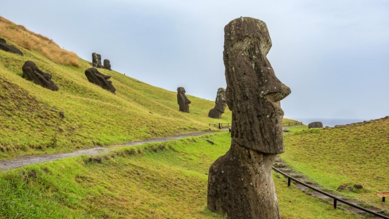 Panoramic view of Easter Island moai statues with volcanic landscape and clear sky