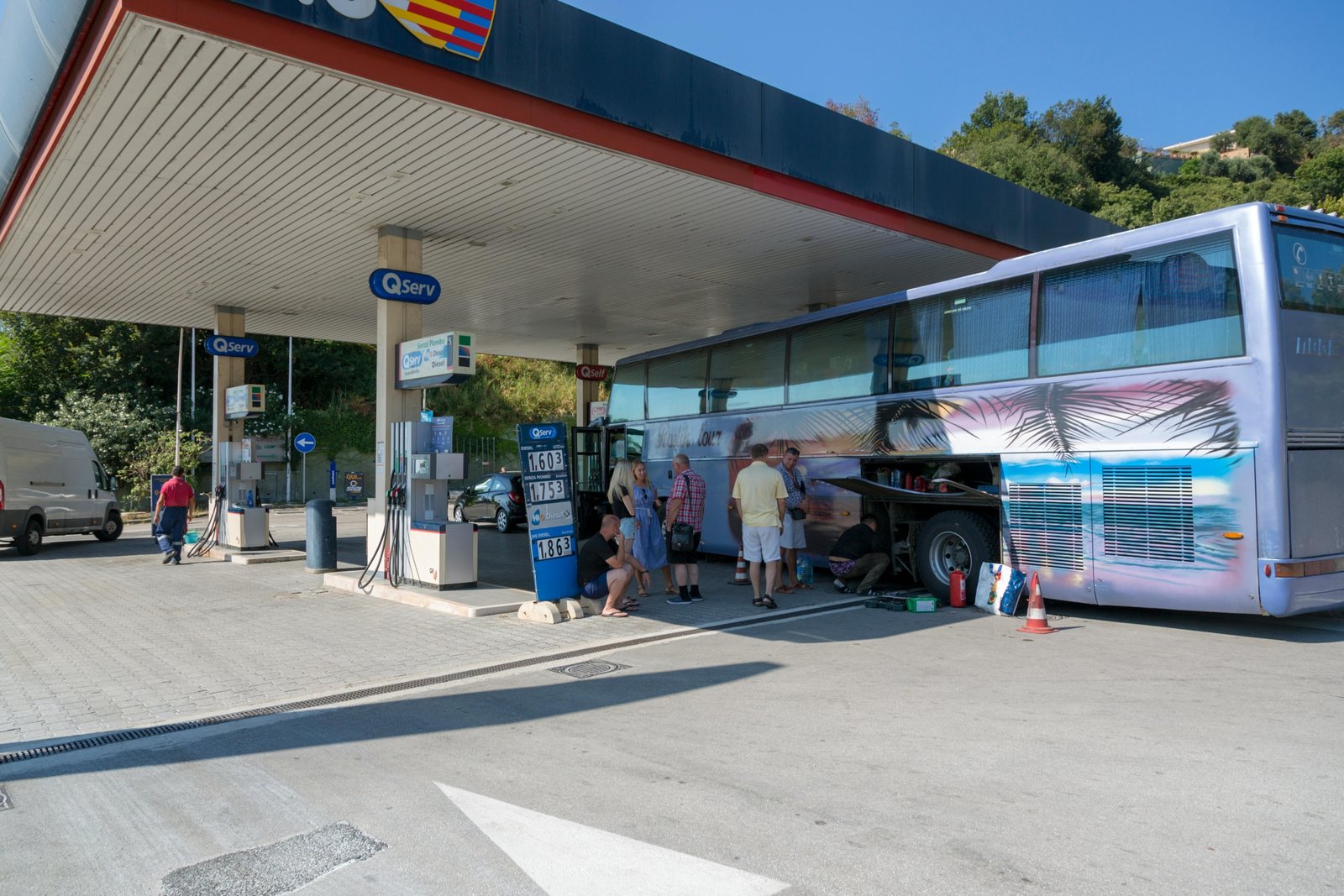 On The Run Travel Center with fuel pumps, fresh food store, and travelers stopping for a break on a busy highway