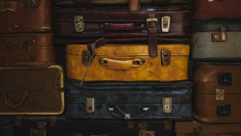 Open makeup travel case with organized cosmetics inside a suitcase, perfect for secure and portable beauty storage while traveling