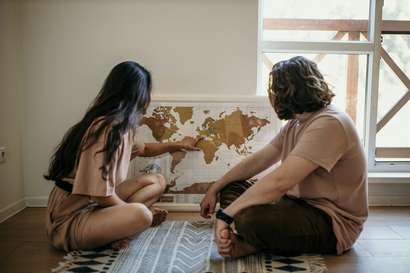 Couple planning their next trip together using a travel map, symbolizing shared adventure and travel planning