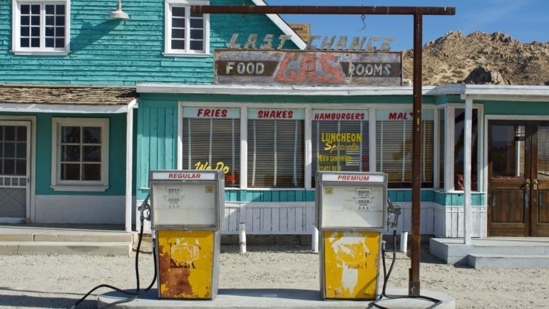 RT 66 Travel Center with fuel pumps, convenience store, and rest area along historic Route 66 highway