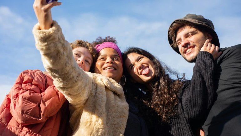 Group of friends enjoying a leisure travel adventure together outdoors, sharing memorable moments and cultural experiences