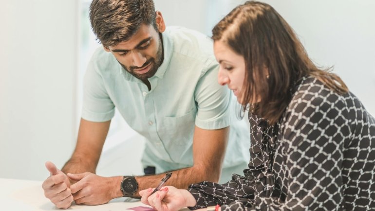 Travel agent consulting client on personalized travel itinerary planning