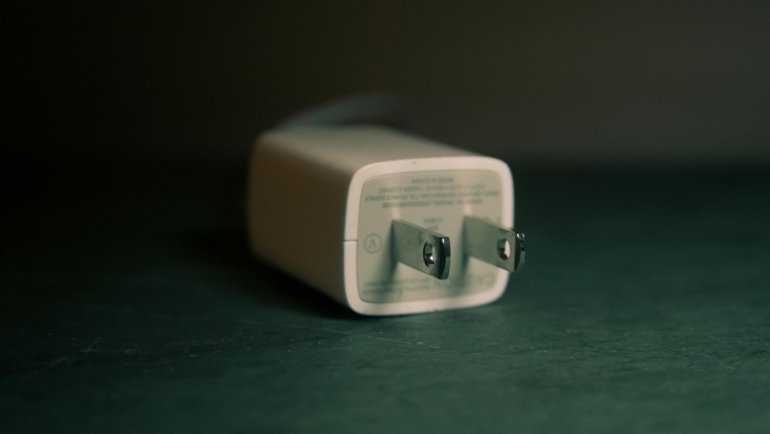 power adapter and voltage converter plugged into Indian electrical socket for safe travel charging