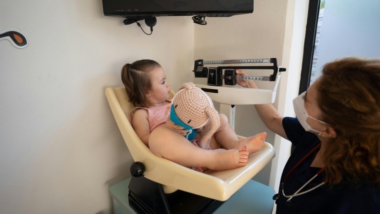 Pediatric travel nurse providing care to a young child in a hospital, representing flexible and rewarding nursing careers