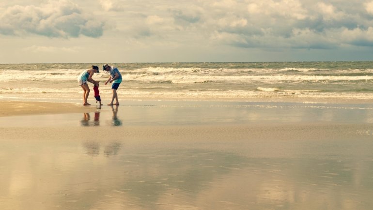 Family enjoying a sunny day camping near the beach at a holiday travel park in Emerald Isle North Carolina
