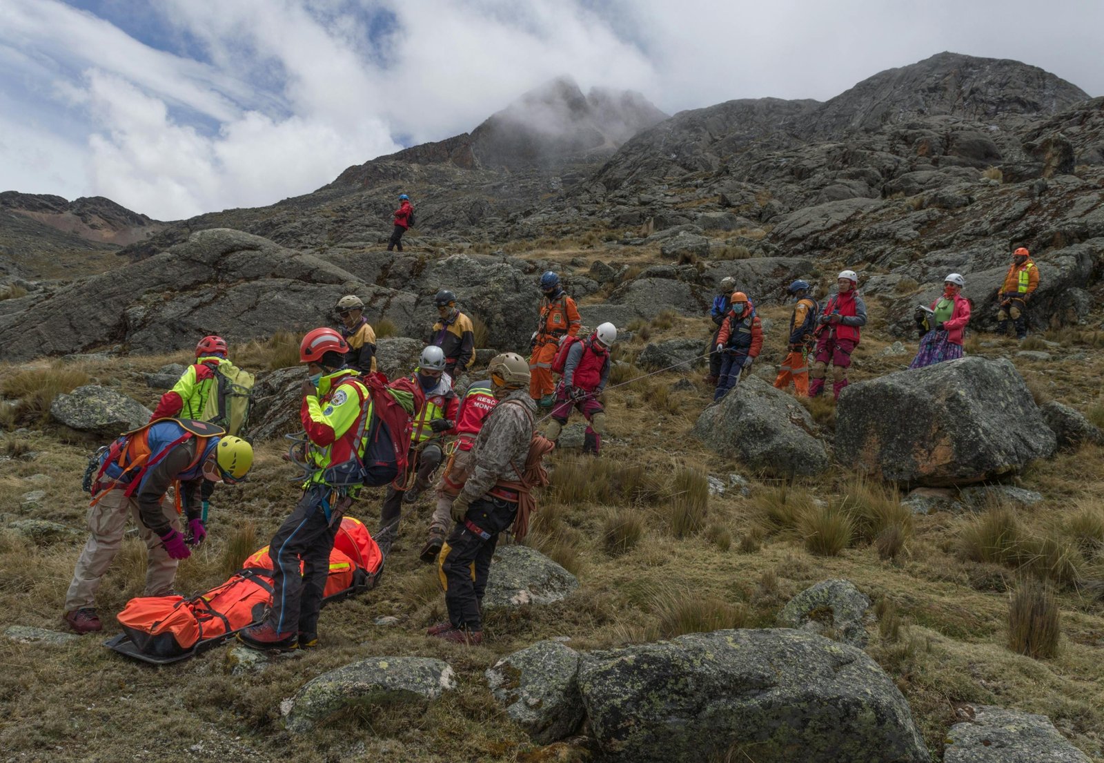 Mountain rescue team assisting injured skier during winter sports trip