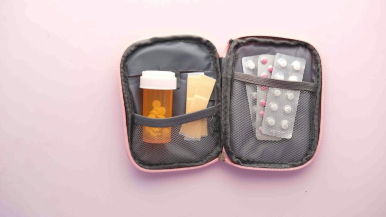 Compact travel size medicine kit with small bottles and blister packs for convenient and safe travel health care