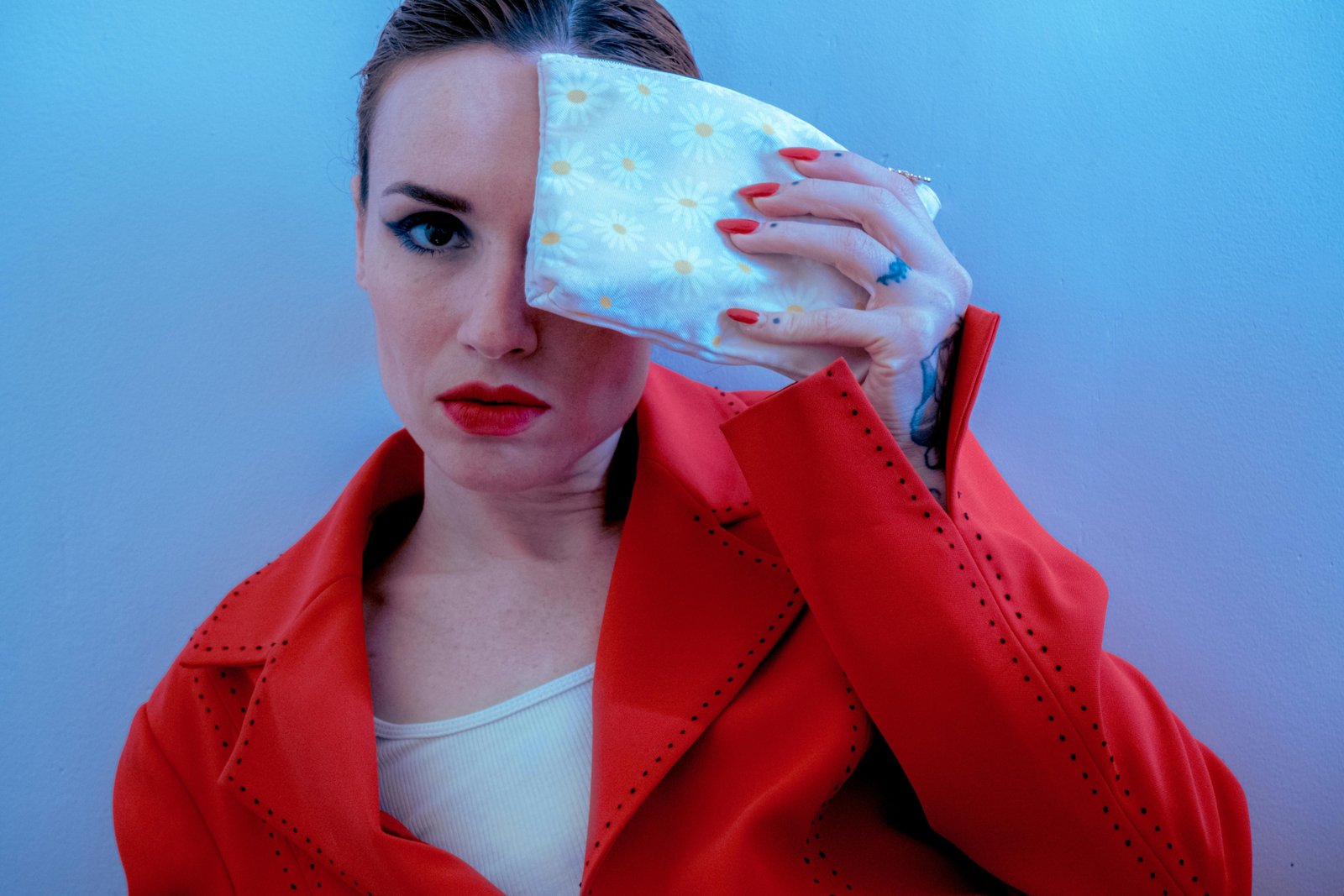 Travel pouch with retro pastel daisy design surrounded by travel accessories showcasing a vintage-inspired stylish organizer