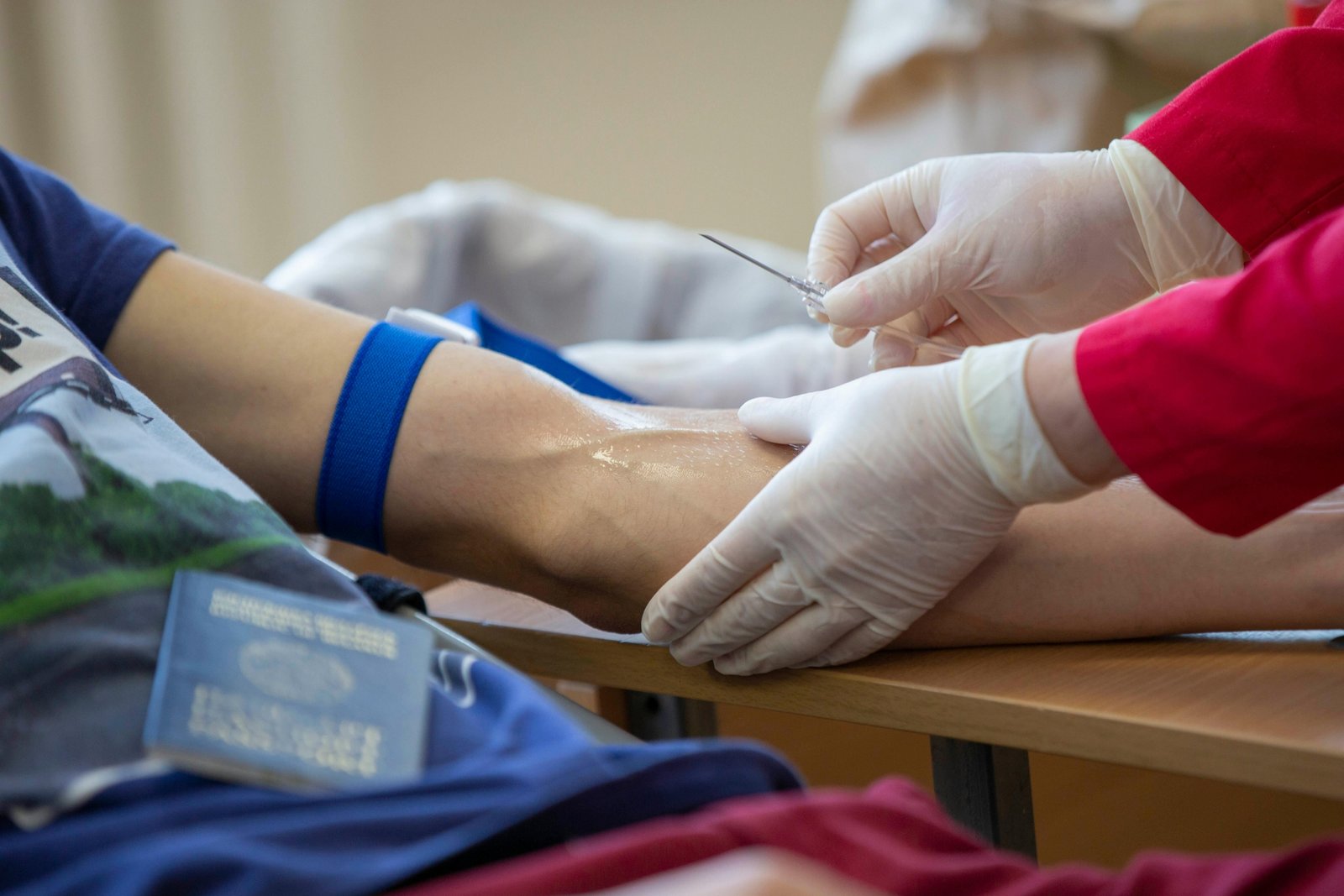 Travel phlebotomist drawing blood in a hospital setting showing flexible healthcare career and travel opportunities