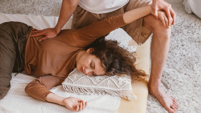 Traveler receiving relaxing massage therapy to relieve travel fatigue and muscle tension