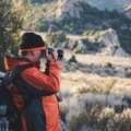 Travel photographer capturing breathtaking landscape during adventure photography assignment
