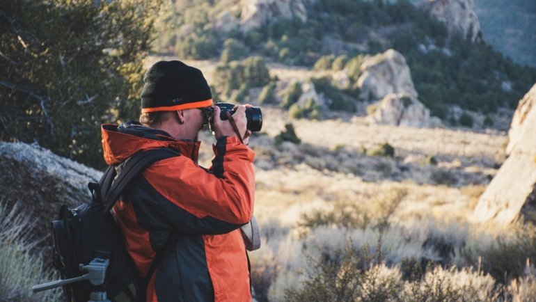 Travel photographer capturing breathtaking landscape during adventure photography assignment