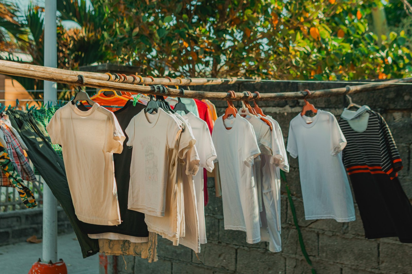 Portable travel clothesline hanging between trees with clothes drying outdoors during a camping trip