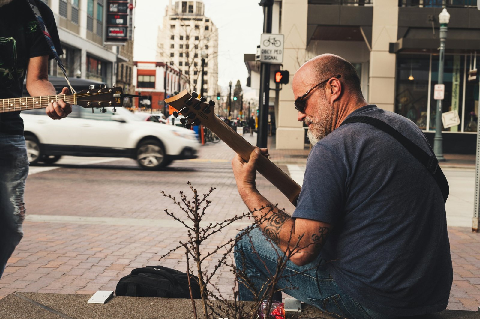 Traveling musician performing outdoors with guitar, embracing freedom and cultural exploration