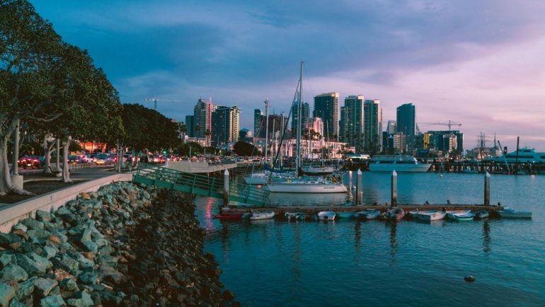 Travel agent helping a client plan a personalized trip in San Diego travel agency office