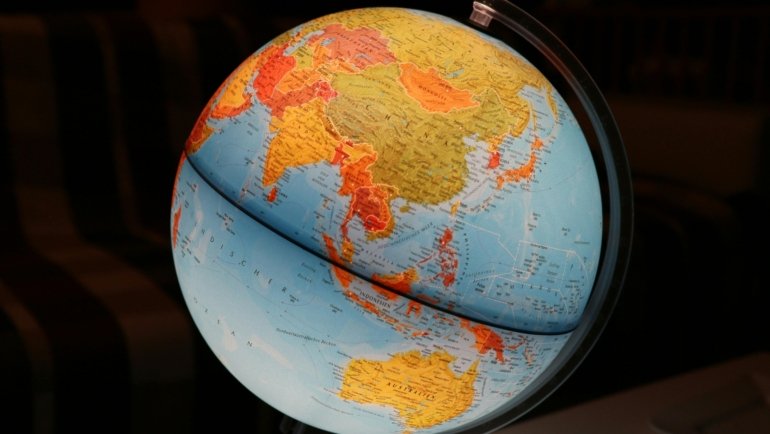 Travel landmarks and globe representing global travel trivia and exploration