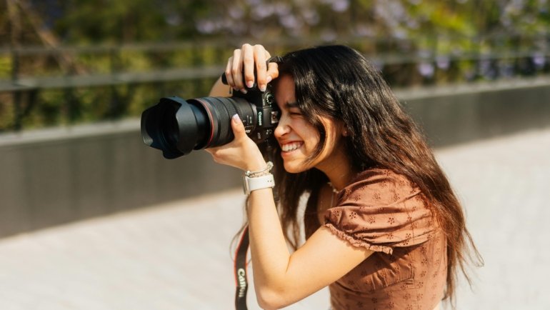 Travel photographer capturing authentic moments in vibrant cultural setting with camera