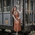Vintage style photo of a woman traveling in Asia with nostalgic 1970s vibe, representing classic adult film travel themes