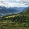 Travel nurse enjoying Alaska wilderness with mountains and forests in the background