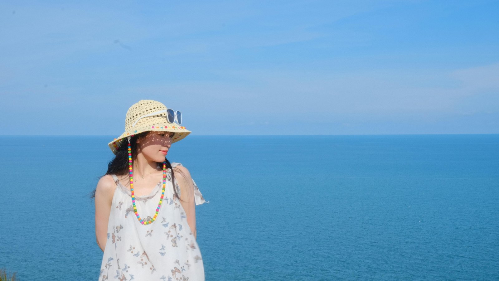 Travelers wearing various sun hats including wide-brim hats, caps, and bucket hats outdoors for sun protection and stylish travel