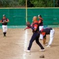 Youth baseball traveling team celebrating together before tournament game, showcasing teamwork and competitive spirit