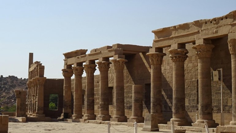 Ancient Egyptian temple in desert under soft sunlight during ideal travel season
