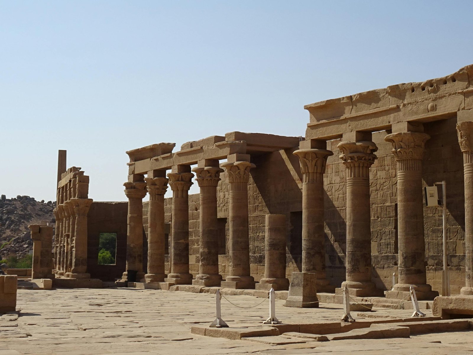 Ancient Egyptian temple in desert under soft sunlight during ideal travel season