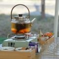 Traveler enjoying portable travel tea with compact tea kit outdoors