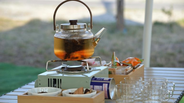 Traveler enjoying portable travel tea with compact tea kit outdoors