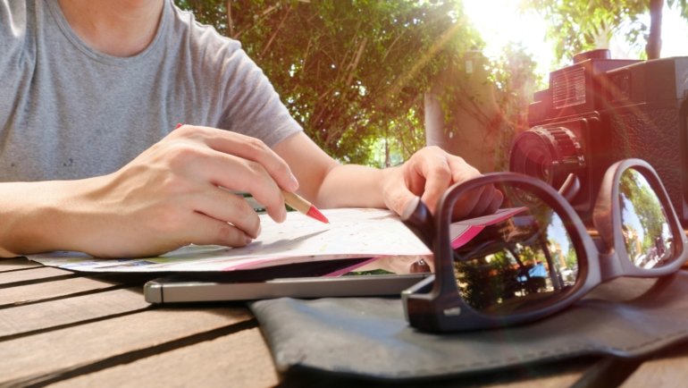 Traveler taking natural supplement pills to prevent traveler's diarrhea while on an international trip